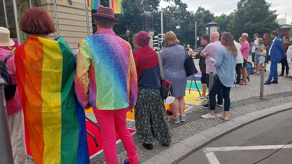 Menschen mit Regenbogenfahnen als Kleidung